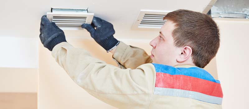 Air conditioning expert checking cooling system